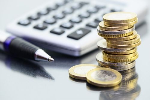 Foto: Taschenrechner, Münzen und Kugelschreiber